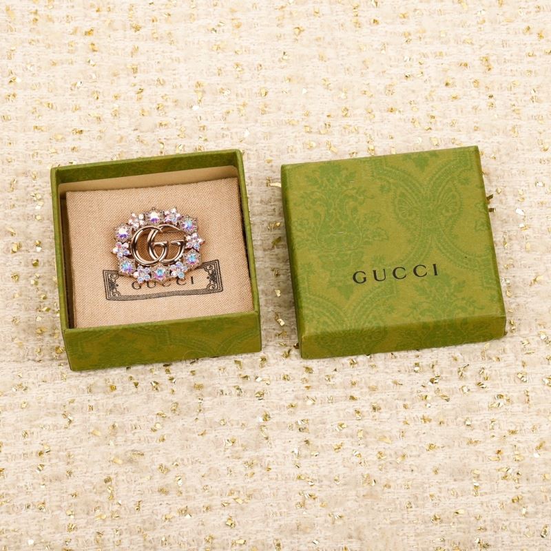 G*u*i brooches
